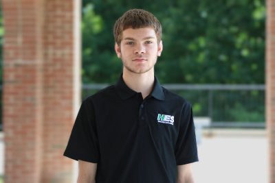 A photo of Noah Houchins in front of University Point at Concord University