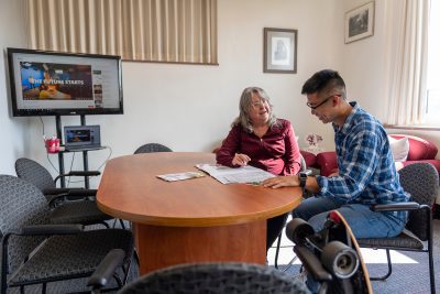 Andrea Tabor reviewing admissions information with a student