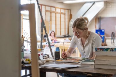 A woman painting in the Alexander Fine Arts Building