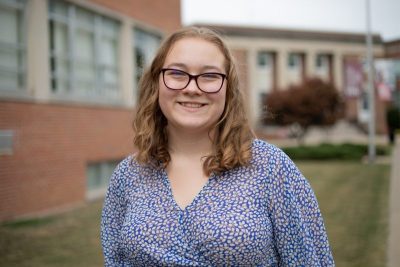 A photo of Abby Stovall in front of the Beasley Student Center