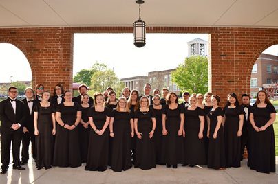 A group photo of the Concord University choir outside of the Wilkes Chapel at University Point