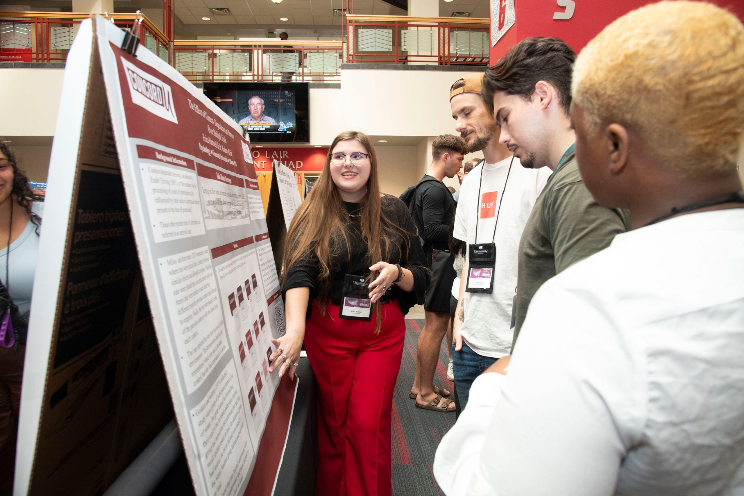 A McNair scholar sharing her research with a small crowd