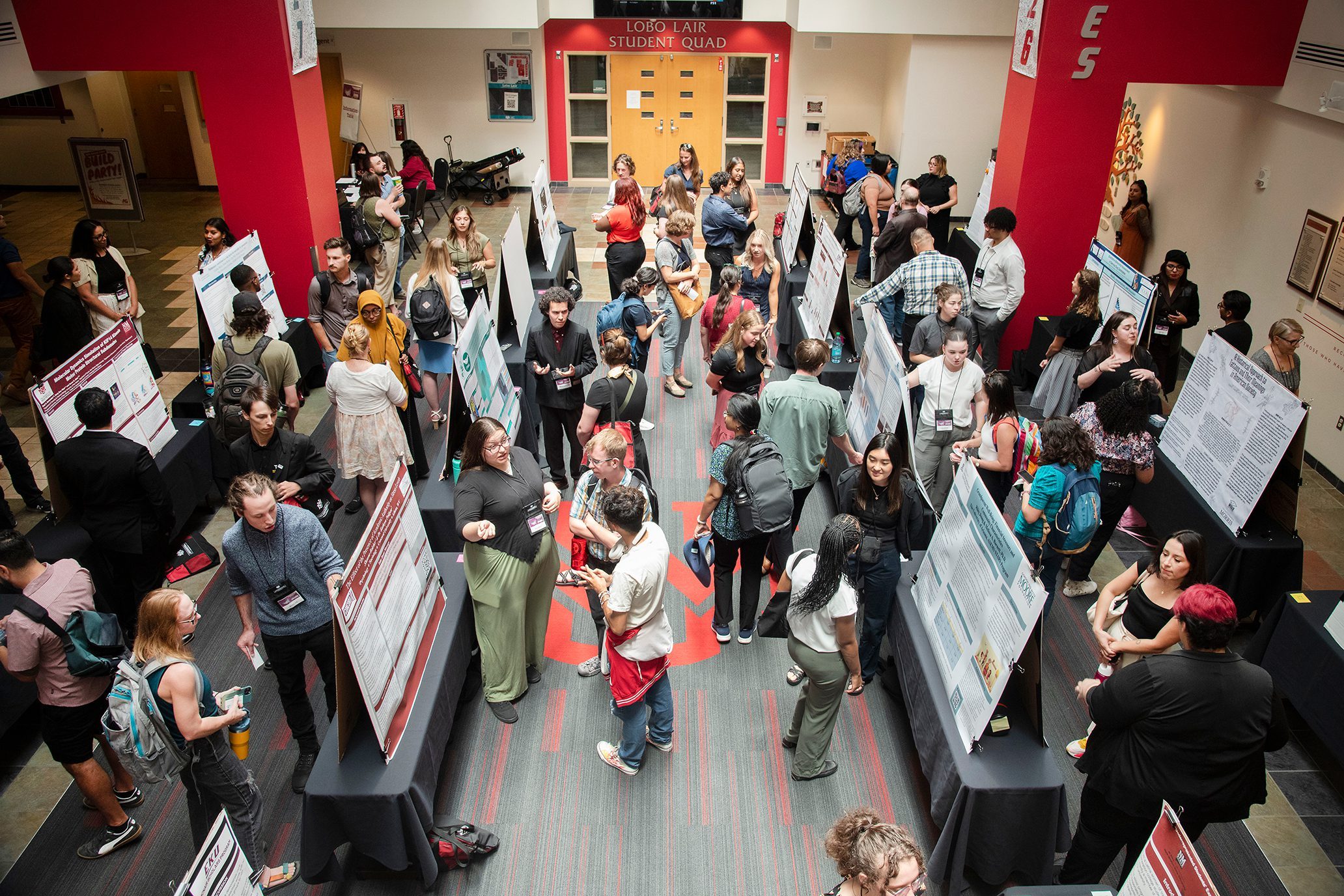 An aerial shot of a McNair conference featuring many students presenting their research posters