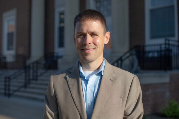 A photo of Adam Coon standing in front of the J. Franklin Marsh Library at Concord University