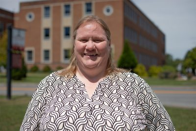 A photo of Amanda Phillips in front of the Science Building