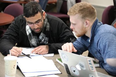 Two Business Administration students working together on an assignment