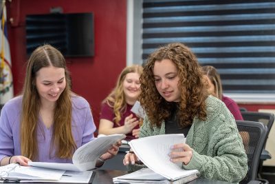 Concord University Education students reading through paperwork in a classroom