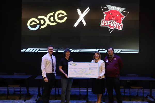 A photo of Concord Esports Marketing & Brand Director Jonathan Rose, Element Federal Credit Union CEO Linda Bodie, Concord University President Dr. Kendra Boggess, and Concord Esports Director Austin Clay with a giant check for ten thousand dollars from Element Federal Credit Union to Concord Esports