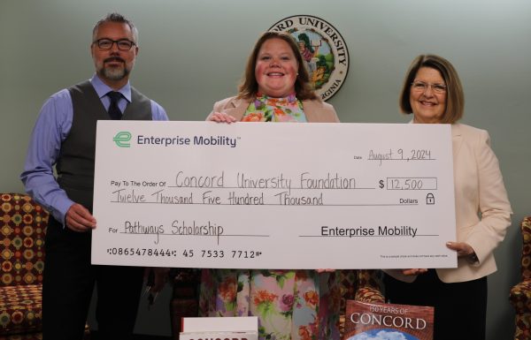 A photo of Concord University's Andrew Sulgit and President Dr. Kendra Boggess being presented a giant check for $12,500 by Caitlin Thompson of Enterprise