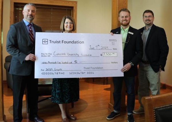 Andrew Sulgit and Dr. Kendra Boggess standing next to representatives from the Truist Foundation holding a giant check for Concord University for seven thousand five hundred dollars