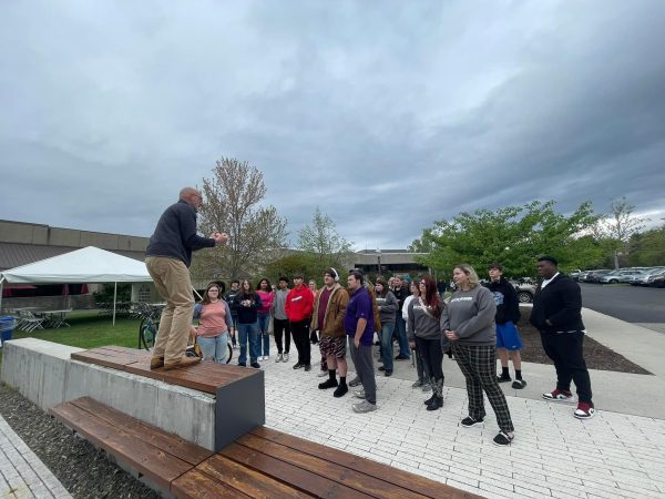 Students from Concord University's Upward Bound program listening to the Dean of the Virginia-Maryland College of Vet Medicine speak in an outdoor area