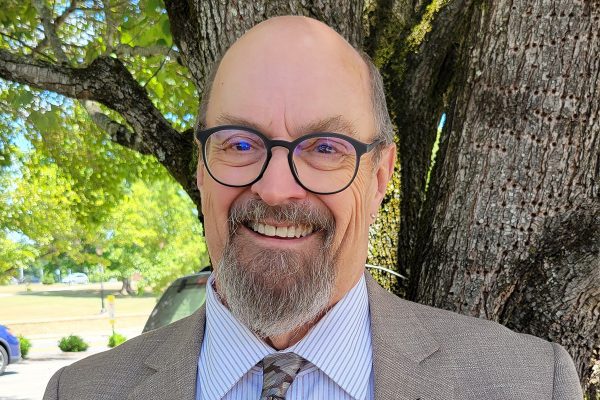 A photo of Provost Ed Huffstetler in front of a tree