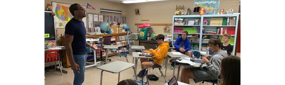 A member of the Student Success Agency speaking with students from Herndon Consolidated in a classroom