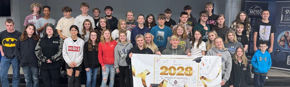 A group of Montcalm students holding a 2028 Promise to Graduate banner.