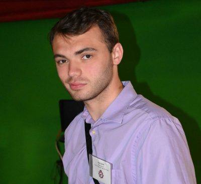 A photo of John Smith in front of a green background