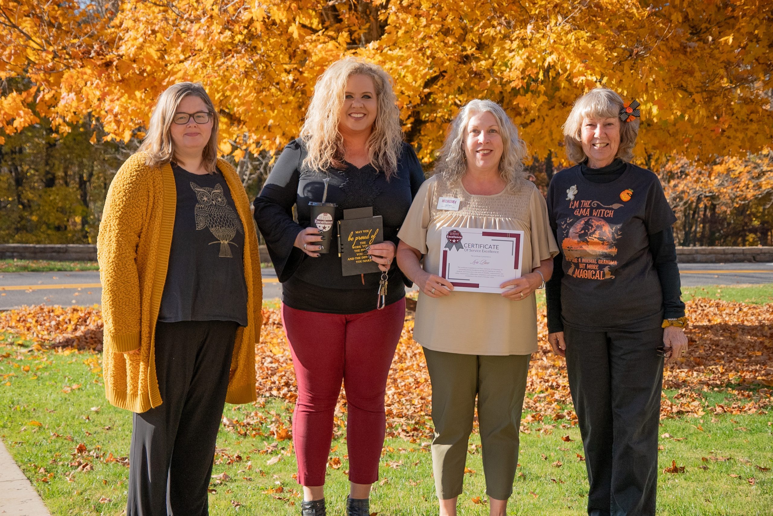 A group photo of Anna Hardy, Lori Pace, Kristen Bailey, and Sharon Manzo on a bright fall day