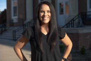 A photo of Michelle Taylor standing in front of the J. Franklin Marsh Library at Concord University