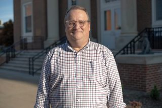 A photo of Steve Simmerman standing in front of the J. Franklin Marsh Library at Concord University