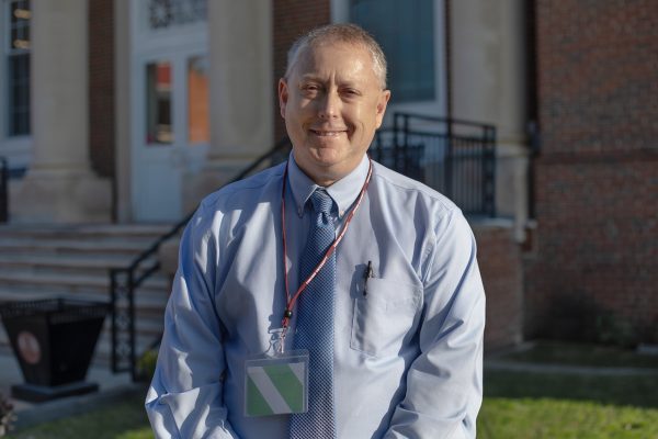 A photo of Tim Anderson standing in front of the J. Franklin Marsh Library at Concord University