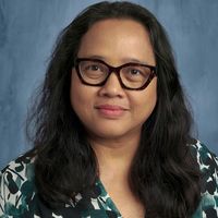 A photo of Angguna Rowe in front of a blue background